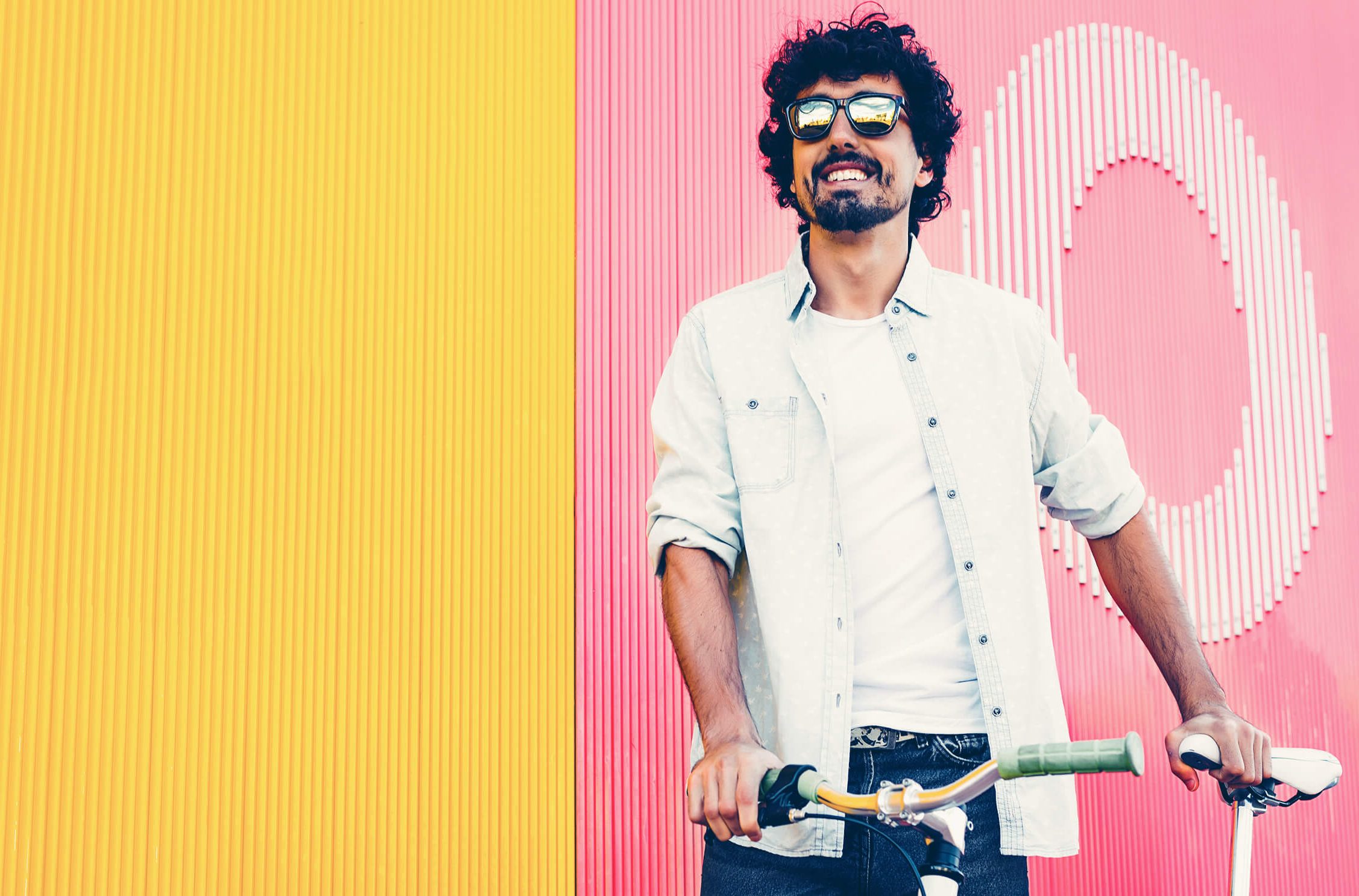 Male outside holding a bicycle