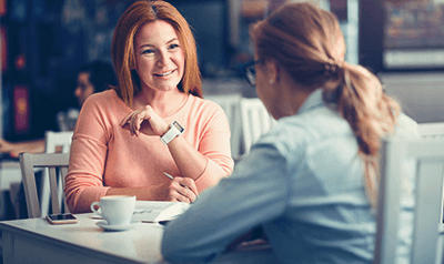 Student sat talking at a table